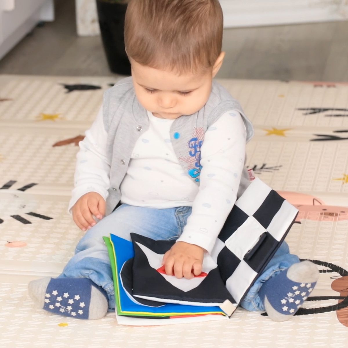 Baby exploring a beiens soft black and white cloth book
